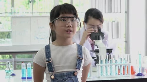 Child Scientist Experiments in Laboratory with Microscope