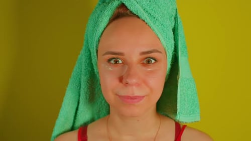 Woman with Eye Patches and Towel on Head
