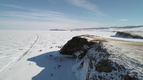 Aerial Above the Rocky Cliff of an Island in Frozen Lake Baikal