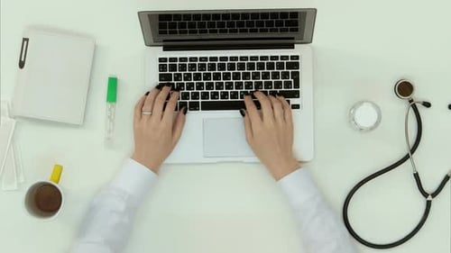 Medical Professional Using Laptop in Clean Office