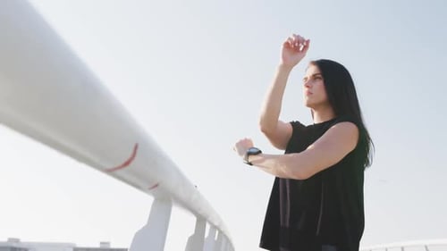 Woman Stretching Arms on Sunny Urban Day