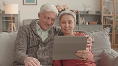 Senior Couple Enjoying Tablet Technology Together at Home