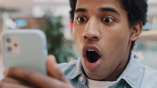 Man Reacts to Content on Smartphone