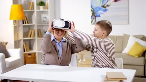 Boy Helping Grandmother Use Virtual Reality Headset