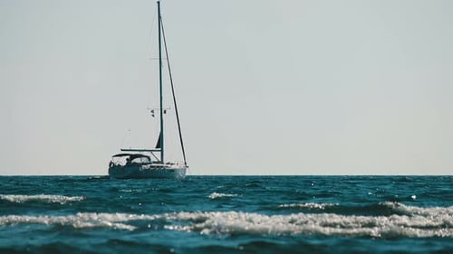 Sailboat Sitting on the Ocean Water on Clear Day