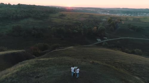 People Exploring Rural Landscape at Scenic Sunrise