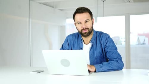 Thumbs Up By Man Working in Office