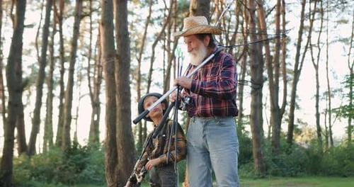 Senior Man and Boy With Fishing Gear