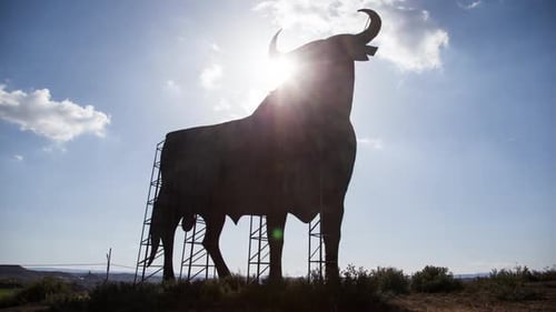 Bull Silhouette Monument Against Bright Sky
