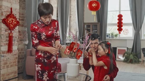 Chinese Family Decorating Branches for Lunar New Year