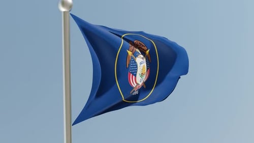 Utah State Flag Waving on Flagpole with Blue Sky Background