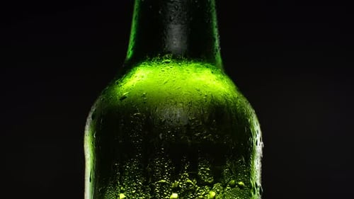 Refreshing Green Glass Bottle with Condensation Close Up