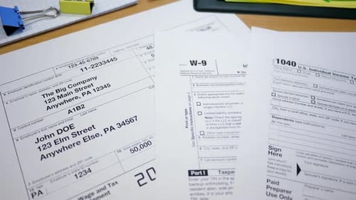 Tax Forms Spread Out on a Wood Desk