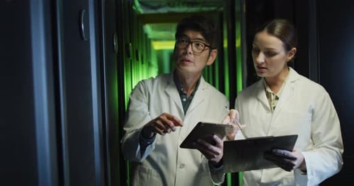 Colleagues Working With Technology in Server Room