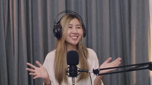 Woman Recording Podcast with Microphone and Headphones