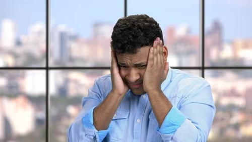 Close Up Young Man Suffering From Migraine