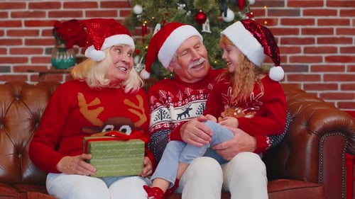 Grandparents and Child Celebrate Christmas at Home
