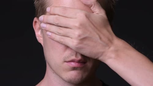 Young Handsome Man Against Black Background