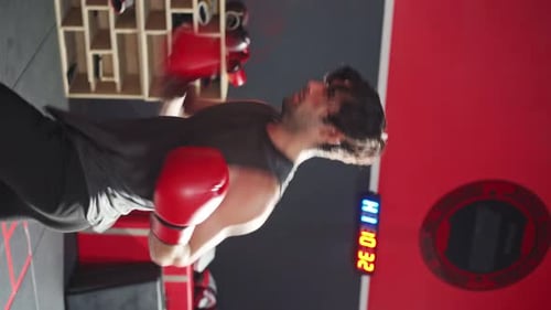 Man Boxing With Punching Bag in Gym