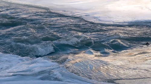 River Flowing Under Frozen Ice Sheets