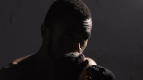 Intense Boxer Training in Dark Boxing Gym