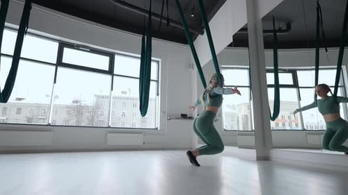 Young Beautiful Woman Practice in Aero Stretching Swing