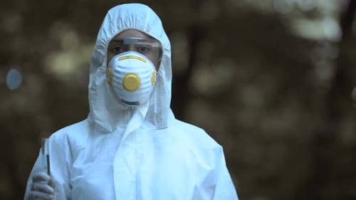 Scientist Holding Test Tube in Protective Gear