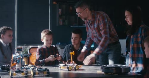 Students Building Robots with Instructors in Classroom
