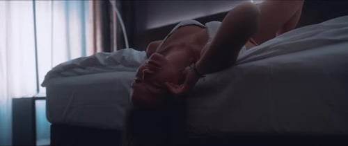 Woman Lying on Bed With Long Brown Hair