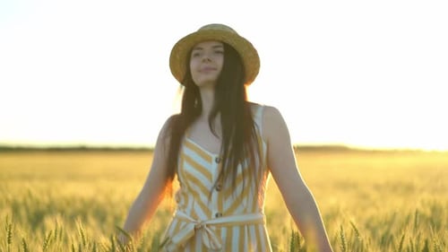 Woman Walking in a Field with Open Arms