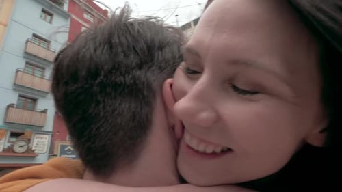 A slow motion of a happy couple hugging on a Valencia square