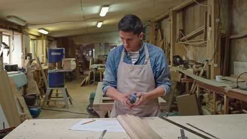 Woodworker Checking Size of Board