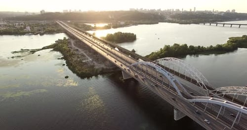 Sunset And Bridge On River