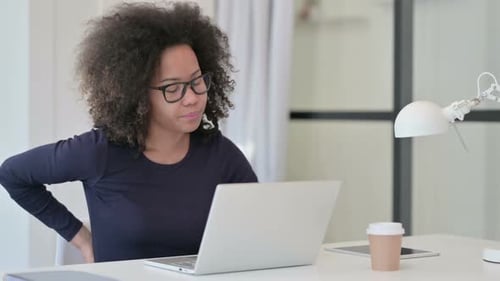 Woman Working at Desk Experiences Back Pain
