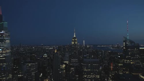 Manhattan and the Empire State Building at night, with illuminations on its top, wide angle and stat