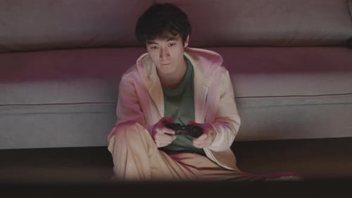 Young Adult Gaming at Home at Night