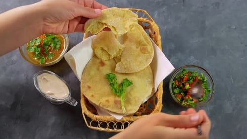 Homemade corn flatbread female hands cilantro green tomato salsa Handmade mexican tortilla vegetable