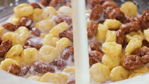 Milk Poured over Bowl of Cereal