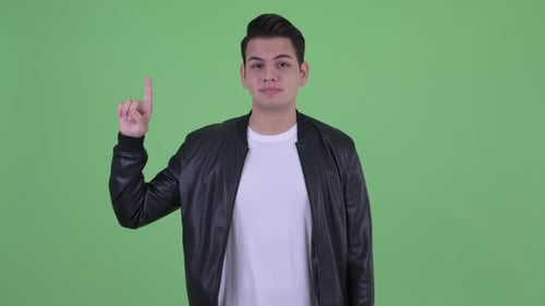 Man Points Up in Front of Green Screen