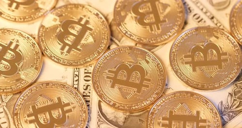 Golden Bitcoin Coins on Top of Dollar