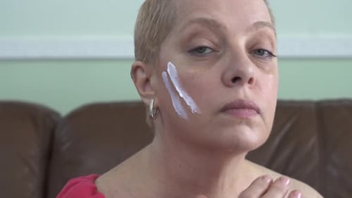 Woman Applying Facial Cream for Skin Care
