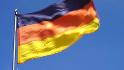 German Flag Waving Against Blue Sky
