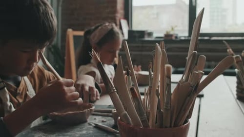 Children Learning Pottery in Art Studio