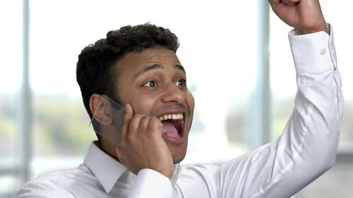 Excited Man Celebrating Good News on Phone