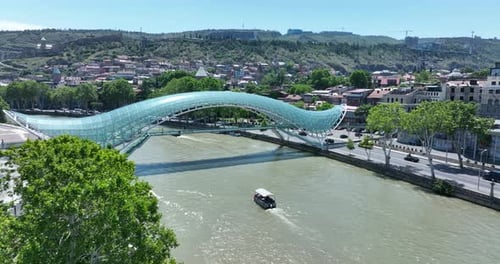 Aerial view of Tbilisi city central park and Bridge of Peace. Beautiful cityscape of old Tbilisi at