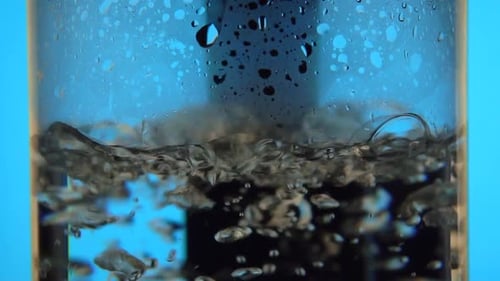 Water Boiling Vigorously in a Clear Glass Kettle
