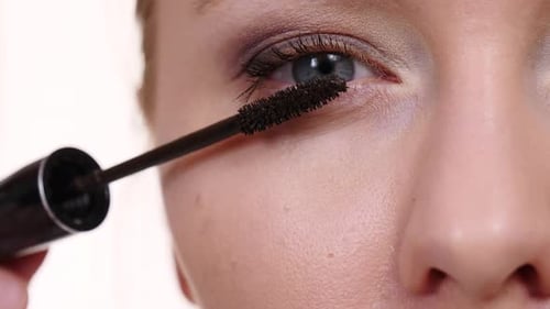 Woman Applies Mascara in Extreme Close Up
