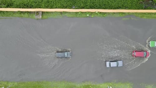 Aerial View of City Traffic with Cars Driving on Flooded Street After Heavy Rain