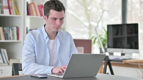 Young Adult Using Laptop Gives Thumbs Up