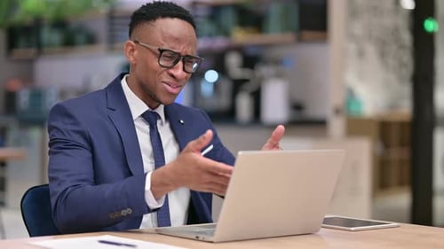Loss, African Businessman Reacting To Failure on Laptop in Office
